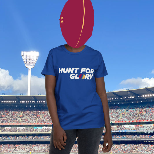 Female wearing a royal blue t-shirt with 'Hunt for Glory' white text in a stadium setting